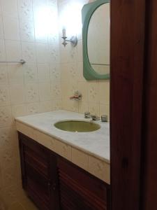 a bathroom with a sink and a mirror at RESONAMUH - Hostel in São Pedro da Aldeia +86 photos
