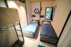 a small room with two beds and a mirror at Dom na plaży in Mrągowo