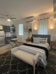 a bedroom with a large bed and a kitchen at calvache city in Centro Calvache