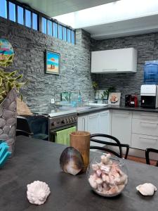 a kitchen with a table with a bowl of food on it at TAMANU LODGE in Punaauia