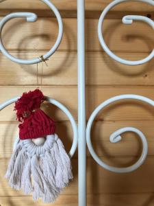 a red and white hat hanging on a wall at Domek w borówkach in Tokarnia +16 photos