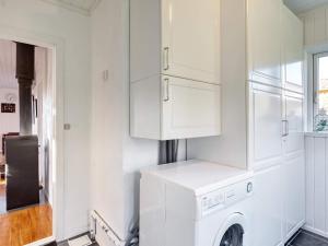 a white laundry room with a washer and dryer at 6 person holiday home in Skibby-By Traum in Skibby