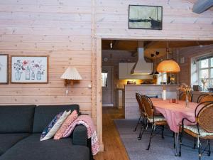 a living room with a couch and a table at 4 person holiday home in Glesborg-By Traum in Glesborg