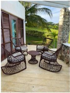 a group of chairs and a table on a patio at VistaLinda, Villa Alamendra in Río San Juan
