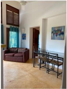 a living room with a couch and a table at VistaLinda, Villa Alamendra in Río San Juan