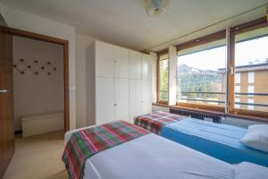 Een bed of bedden in een kamer bij Appartamento con Vista! A Due Passi dalle Piste