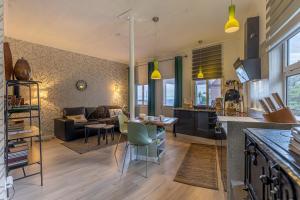a kitchen and living room with a couch and a table at Villa Sophia by ALMA Holiday Rentals in Caniço