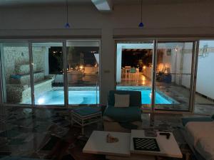 a living room with a view of a swimming pool at Villa LAGUNA in Lowlands