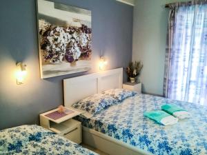 a small bedroom with two beds and a window at Athina Studios in Argasi