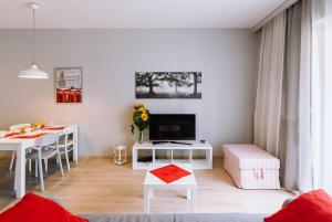 a living room with a table and a dining room at ApartmentPrestige Central Station in Krakow