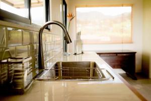 a kitchen counter with a sink and a window at Coffee Garden Ranch Costa Rica in Concepción