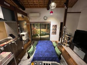 a room with a bed in the middle of a room at Nishijin no Sato 西陣之郷 -100 yrs Smart & Sustainable AI Arthouse with 10Gbps wifi - in Kyoto