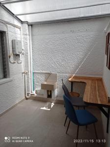 a room with a table and chairs in a garage at Estadio APARTE HOTEL 203 in Medellín