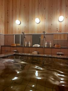 a swimming pool in a room with wooden walls at Kabuto Villas ー古民家ステイー 