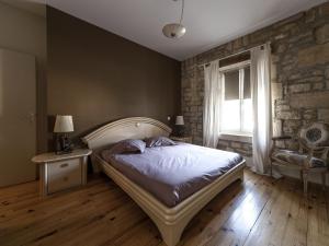 a bedroom with a bed and a chair and a window at Gîte L'Isle-en-Rigault, 4 pièces, 8 personnes - FR-1-585-55 in Lisle-en-Rigault