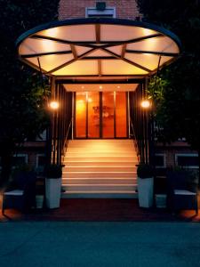 un escalier menant à un bâtiment éclairé. dans l'établissement Hotel Globo, à Formigine