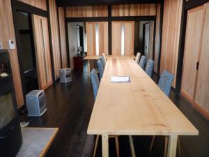 a conference room with a long wooden table and chairs at Kabuto Villas ー古民家ステイー 