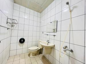 łazienka z toaletą i umywalką w obiekcie Xingang Homestay w mieście Xingang