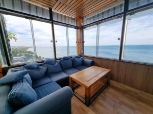 Una sala de estar con un sofá azul y una mesa. en Ngoc Chau Phu Quoc Hotel, en Phu Quoc