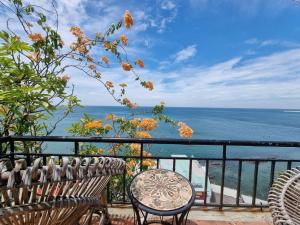balcón con mesa, sillas y vistas al océano en Ngoc Chau Phu Quoc Hotel en Phu Quoc