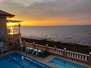 une maison avec une piscine et l'océan dans l'établissement Ocean Breeze Resort, à Toledo City