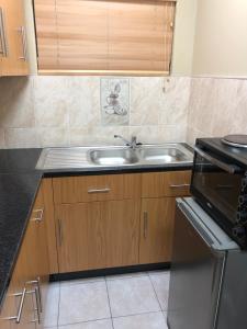 a kitchen with a sink and a stove at Q’s in Empangeni