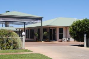 a building with a gate in front of it at Cobar Central Motor Inn in Cobar