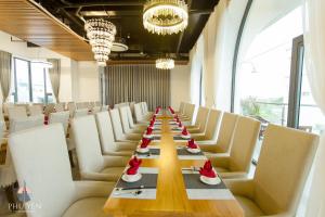 a long dining room with a long table and white chairs at PHÚ YÊN EVERYDAY HOTEL in Tuy Hoa +150 photos