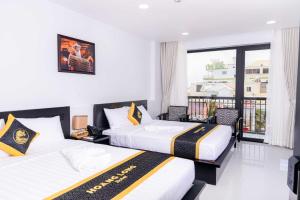 Postel nebo postele na pokoji v ubytování Hoang Long Hotel Phan Thiết