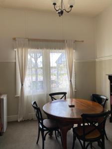 a dining room with a table and chairs and a window at Dunkeld Old Bakery Accommodations in Dunkeld