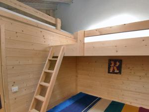 a wooden bunk bed with a ladder in a room at Appartement Val-d'Isère, 3 pièces, 6 personnes - FR-1-694-37 in Val-d'Isère