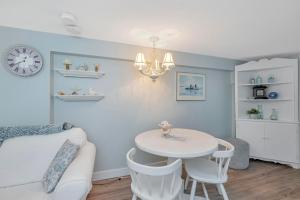 a living room with a white table and chairs at Quaint 1 bedroom lower suite in Victoria, BC in Victoria