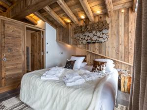 a bedroom with a large white bed with wooden walls at Appartement Val-d'Isère, 5 pièces, 8 personnes - FR-1-694-89 in Val-d'Isère