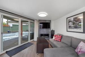 a living room with a couch and a fireplace at Tranquil Oasis 2 bedroom Suite with Pool View in Victoria