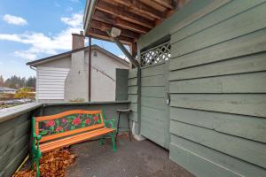 a bench sitting on the side of a building at Tranquil Oasis 2 bedroom Suite with Pool View in Victoria