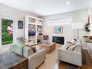 a living room with two couches and a fireplace at The Red Feather Inn in Launceston