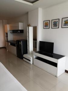 a kitchen with a black refrigerator and a counter top at Grand Residence Jomtien in Jomtien Beach