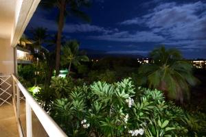 a view from the balcony of a resort at night at Maui Banyan H311 1BD 2BA 3 min walk to the beach in the Heart of South Kihei! in Wailea