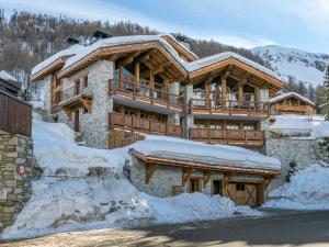 a large wooden house with snow around it at Appartement Val-d'Isère, 4 pièces, 8 personnes - FR-1-694-102 in Val-d'Isère