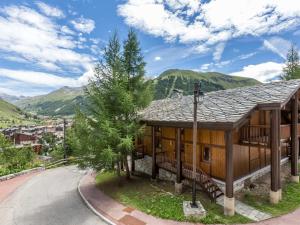 a house in the mountains with a road next to it at Appartement Val-d'Isère, 3 pièces, 6 personnes - FR-1-694-103 in Val-d'Isère