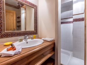 a bathroom with a sink and a mirror and a shower at Appartement Val-d'Isère, 5 pièces, 8 personnes - FR-1-694-106 in Val-d'Isère