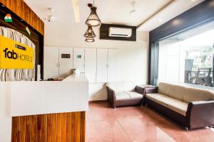 una sala de espera con un sofá y una mesa en FabHotel Amour - Nr Mumbai International Airport, en Bombay