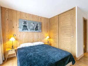 a bedroom with a bed with wooden walls and two lamps at Appartement Val-d'Isère, 3 pièces, 5 personnes - FR-1-694-206 in Val-d'Isère