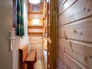 a hallway with a wooden wall and a wooden bench at Appartement chaleureux 6 pers skis aux pieds avec parking couvert au coeur de Val-d'Isère - FR-1-694-229 in Val dʼIsère