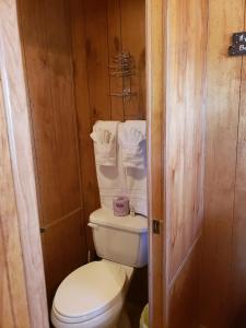 a small bathroom with a toilet and towels at Stampede RV B&B in Tombstone +33 photos