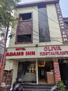 a building with a sign that reads olima adams inn at Hotel Adams Inn Near Mumbai Airport in Mumbai