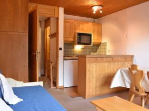 a small kitchen with a counter and a microwave at Appartement Méribel, 1 pièce, 3 personnes - FR-1-180-19 in Méribel