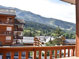 a view from a balcony of a town with mountains at Appartement Méribel, 1 pièce, 4 personnes - FR-1-180-4 in Méribel