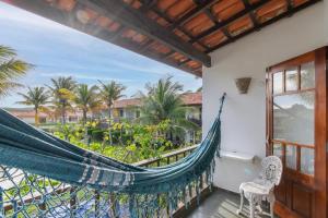 a hammock on a balcony with a view of the ocean at Búzios casa 41 in Búzios