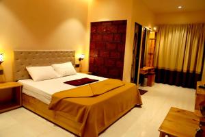 a bedroom with a large bed in a room at Sara green Valley Farm in Mahabaleshwar